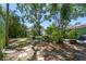 Lush backyard featuring mature trees, garden area, and outdoor patio space at 220 22Nd Se Ave, St Petersburg, FL 33705