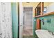 Well-lit bathroom with vintage turquoise tile, white fixtures, and modern updates at 220 22Nd Se Ave, St Petersburg, FL 33705