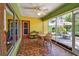 Bright, enclosed sunroom with tiled floor, ceiling fan, and direct access to the backyard at 220 22Nd Se Ave, St Petersburg, FL 33705