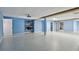 Spacious basement with bright blue walls, projector, and open doorways at 2605 59Th S St, Gulfport, FL 33707