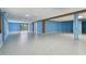 Large basement with epoxy flooring, light blue support beams, and access to the outdoors via sliding glass doors at 2605 59Th S St, Gulfport, FL 33707