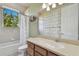 Bathroom featuring vanity with framed mirror, a toilet, and tub with shower curtain at 2605 59Th S St, Gulfport, FL 33707