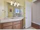Bright bathroom featuring a single sink vanity with a shower seen in the mirror at 2605 59Th S St, Gulfport, FL 33707