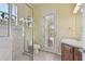 Bathroom featuring a glass-enclosed shower and toilet near a door to the lanai at 2605 59Th S St, Gulfport, FL 33707