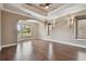 Spacious bedroom featuring hardwood floors, tray ceiling, large windows with natural light, and designer touches at 2605 59Th S St, Gulfport, FL 33707