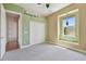 Bedroom with large window and large closet with green accent wall at 2605 59Th S St, Gulfport, FL 33707