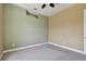 A neutral bedroom with green accent wall and a ceiling fan at 2605 59Th S St, Gulfport, FL 33707