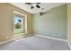Bright bedroom featuring carpet floors, a window view, and a ceiling fan at 2605 59Th S St, Gulfport, FL 33707