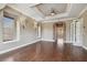 Spacious bedroom with hardwood floors, tray ceiling, an archway, and natural light, creating a comfortable retreat at 2605 59Th S St, Gulfport, FL 33707