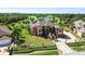 Elegant two-story home with lush landscaping, brick driveway, and golf course views at 2605 59Th S St, Gulfport, FL 33707