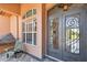 Elegant front entrance features custom iron doors and a cozy porch area with beautiful brick pavers at 2605 59Th S St, Gulfport, FL 33707