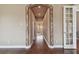 Hallway featuring hardwood floors, trim, and entry to a bathroom at 2605 59Th S St, Gulfport, FL 33707