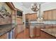 Well-appointed kitchen featuring custom cabinetry, stainless steel appliances, and granite countertops with center island at 2605 59Th S St, Gulfport, FL 33707
