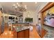 Gourmet kitchen with island, granite countertops, chandelier, and backyard view at 2605 59Th S St, Gulfport, FL 33707