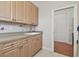 Laundry room with wooden cabinets, sink, and tile flooring at 2605 59Th S St, Gulfport, FL 33707
