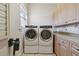 This laundry room features a washer, a dryer, and built in cabinets at 2605 59Th S St, Gulfport, FL 33707