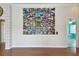 Large wall collage enhances the living room with wood floors and doorway to bright room at 2605 59Th S St, Gulfport, FL 33707