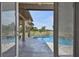 View of the pool and patio area through the glass doors at 2605 59Th S St, Gulfport, FL 33707