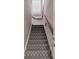 Carpeted staircase with wooden handrail and natural light at 2605 59Th S St, Gulfport, FL 33707