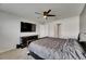 Well-lit bedroom showing a queen bed, TV, and closet access at 2805 Gumbo Limbo Dr, Wimauma, FL 33598