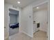 Hallway showcasing a laundry room and a bedroom with 2 beds at 2805 Gumbo Limbo Dr, Wimauma, FL 33598