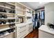 Walk-in closet with custom shelving, drawers, and ample storage space at 2950 Meadow Hill Dr, Clearwater, FL 33761