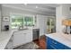 Bright eat-in kitchen featuring granite countertops, stainless steel appliances, hardwood floors and view to the pool at 2950 Meadow Hill Dr, Clearwater, FL 33761