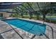 Relaxing screened-in pool area with views of a golf course and pond at 2950 Meadow Hill Dr, Clearwater, FL 33761