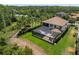 Backyard aerial view featuring a screened-in pool, outdoor seating, and lush green surroundings at 3100 Barbour Trl, Odessa, FL 33556
