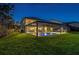 Exterior shot of the home and backyard at night with pool at 3100 Barbour Trl, Odessa, FL 33556