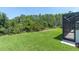 View of backyard and surrounding forest from inside the screened in porch of home at 3100 Barbour Trl, Odessa, FL 33556