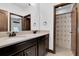 Bathroom features a double sink vanity with framed mirror, and shower with decorative curtain at 3100 Barbour Trl, Odessa, FL 33556
