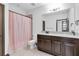 Bathroom featuring tiled floors, granite countertops, and pink shower curtain at 3100 Barbour Trl, Odessa, FL 33556