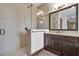 Tiled bathroom featuring a glass shower and dark wood cabinets at 3100 Barbour Trl, Odessa, FL 33556