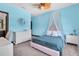 Stylized blue bedroom featuring a ceiling fan, canopy bed, and a decorative mirror at 3100 Barbour Trl, Odessa, FL 33556