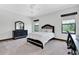 Bedroom features a stylish bed frame, dresser, and natural light from two windows at 3100 Barbour Trl, Odessa, FL 33556
