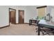 Bedroom features a desk area, neutral carpet, and two doors for easy access at 3100 Barbour Trl, Odessa, FL 33556