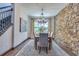 Charming dining room with stone accent wall, chandelier, and view of the staircase at 3100 Barbour Trl, Odessa, FL 33556