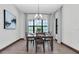 Cozy dining room featuring wood floors and a picturesque window view, perfect for Gathering meals at 3100 Barbour Trl, Odessa, FL 33556
