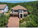 Stately two-story home with a tile roof, manicured landscaping, and a three-car garage at 3100 Barbour Trl, Odessa, FL 33556