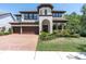 Stunning two-story home with a beautiful tile roof, manicured landscaping, and a three-car garage at 3100 Barbour Trl, Odessa, FL 33556