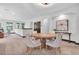 Spacious game room featuring a round table, upholstered chairs, and abundant natural light at 3100 Barbour Trl, Odessa, FL 33556