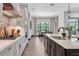 Open-concept kitchen showcasing stainless steel appliances and direct view into the adjacent dining area at 3100 Barbour Trl, Odessa, FL 33556