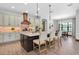 Bright and airy kitchen featuring a central island with bar stool seating and pendant lighting at 3100 Barbour Trl, Odessa, FL 33556