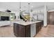 Spacious kitchen island with granite countertops and stainless steel appliances overlooking the living area at 3100 Barbour Trl, Odessa, FL 33556
