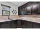 Kitchenette with dark wood cabinetry, counter space, window and decorative plates at 3100 Barbour Trl, Odessa, FL 33556