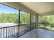 Outdoor lanai providing serene views of lush greenery and a glimpse of the pool below at 3100 Barbour Trl, Odessa, FL 33556