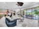 Open living room showcasing the modern kitchen, dining area, and screened-in pool through sliding glass doors at 3100 Barbour Trl, Odessa, FL 33556