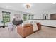 Bright living room featuring stylish furniture, neutral colors, and natural light from large windows at 3100 Barbour Trl, Odessa, FL 33556