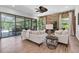 This open concept living room has a stone accent wall, fan and sliding doors leading to the pool at 3100 Barbour Trl, Odessa, FL 33556